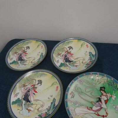 LOT 115. FOUR ASIAN THEME HOME DECOR PLATES
