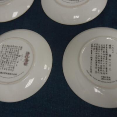 LOT 115. FOUR ASIAN THEME HOME DECOR PLATES