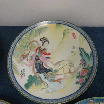 LOT 115. FOUR ASIAN THEME HOME DECOR PLATES