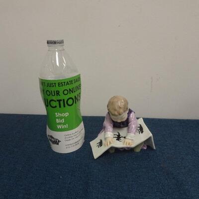 LOT 215 MEISSEN FIGURINE CHILD LOOKING AT PICTURE BOOK