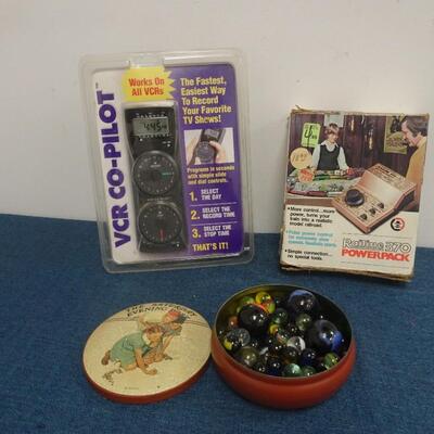 LOT 308.  MISC ITEMS. MARBLES, MODEL RAIL ROAD POWER PACK AND VCR CO PILOT