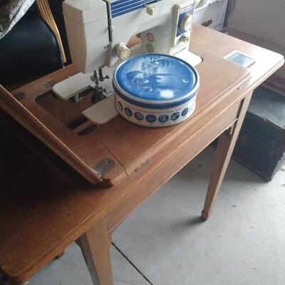Sewing machine with folding down custom desk