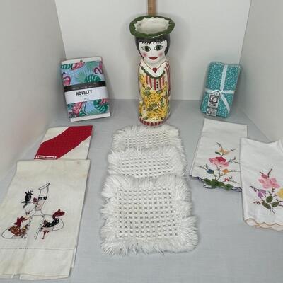 Assorted linens, fabric, trivets, vase