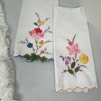 Assorted linens, fabric, trivets, vase