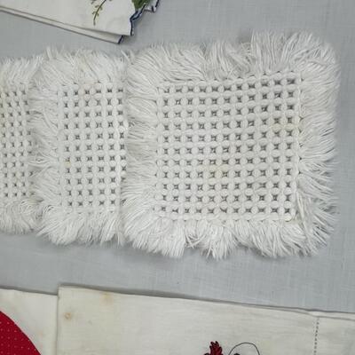 Assorted linens, fabric, trivets, vase