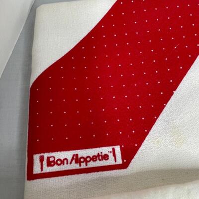 Assorted linens, fabric, trivets, vase