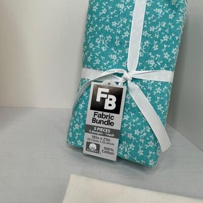 Assorted linens, fabric, trivets, vase