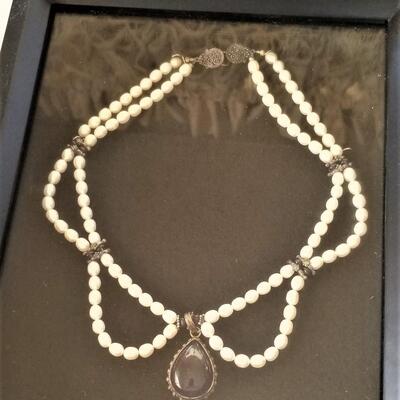 Lot #116  Cabochon Amethyst & Natural pearl festoon necklace in shadow box
