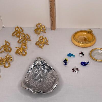 Metalware, napkin rungs, saucers, miniature animals, glass dish with lid