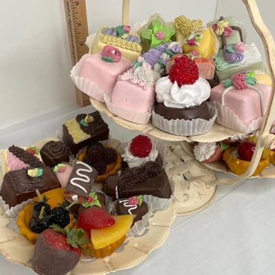 Realistic fake candies on rustic looking 3 tiered tray