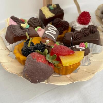 Realistic fake candies on rustic looking 3 tiered tray