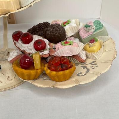 Realistic fake candies on rustic looking 3 tiered tray