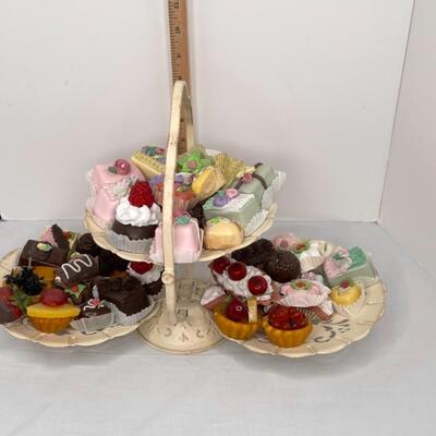 Realistic fake candies on rustic looking 3 tiered tray
