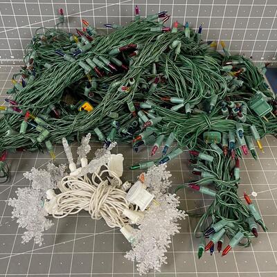 7 Green Strings of Multi Colored Lights and 1 string of Snow flake 