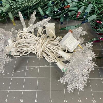 7 Green Strings of Multi Colored Lights and 1 string of Snow flake 