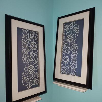 2 framed blue and white art