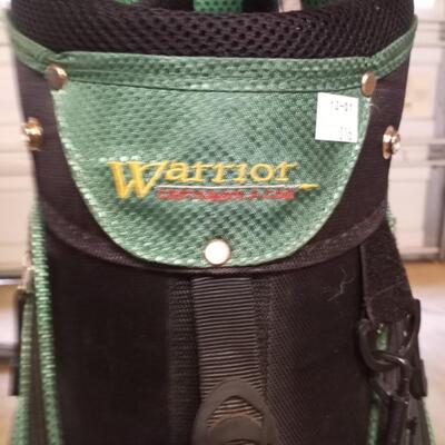 Black and green Warrior golf bag with 6 clubs and specialty tool and bag