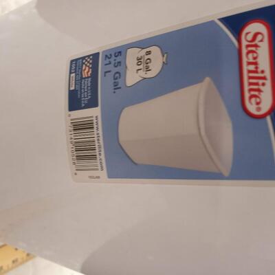 white wastebasket trash can