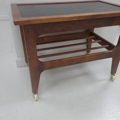 LOT 337. MCM END TABLE  WITH PLASTIC WHEELS NEEDS REPAIR