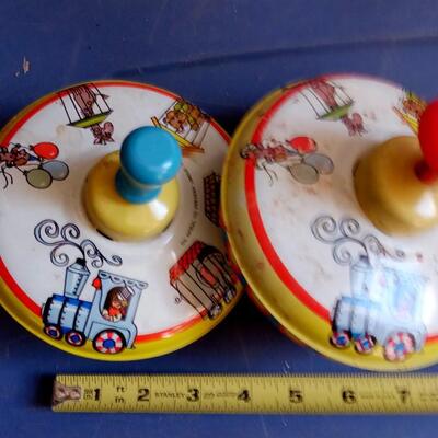 LOT 142  TWO OLD METAL TOY TOPS
