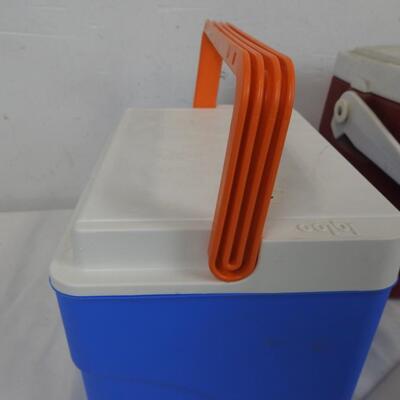 2 Small Coolers: 1 Blue Igloo Cooler with Orange Handle, Red Coleman Cooler