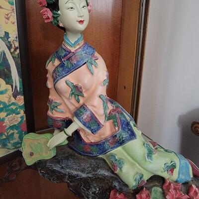 Oriental doll laying on its side