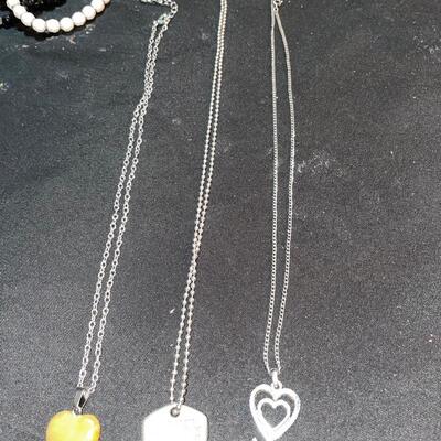 Four pendants with included chains