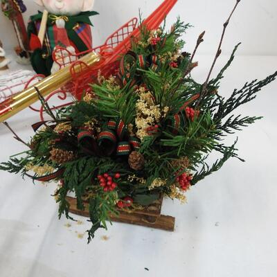 Christmas Decorated Sleds, Santa Figurines, Candles, Baskets with Faux Flowers