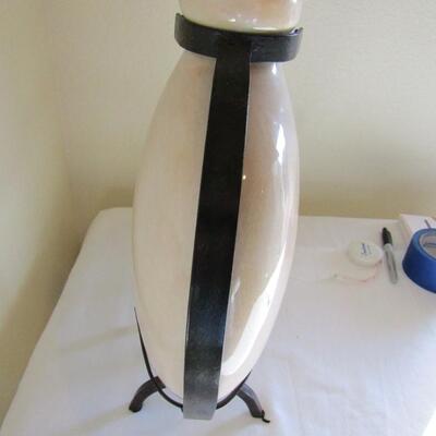 LOT 11  CERAMIC VASE IN A WROUGHT IRON HOLDER