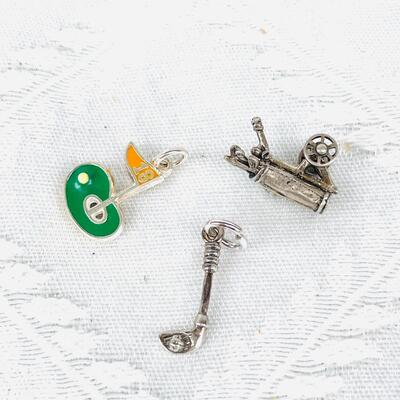 GROUP OF THREE GOLF THEMED STERLING SILVER CHARMS