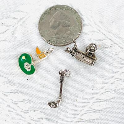 GROUP OF THREE GOLF THEMED STERLING SILVER CHARMS