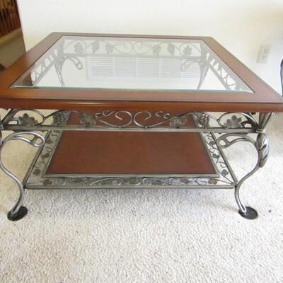 LOT 35  TWO TIER ORNATE IRON COFFEE TABLE WITH GLASS TOP