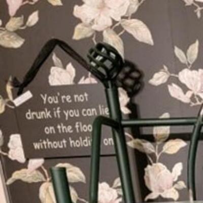 black wall sign drunk on floor