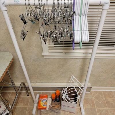 clothing rack, hangers, hat dishwater safe basket and misc laundry supplies