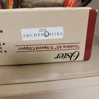 oster hair clipper lot with lots of attachments