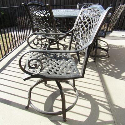 LOT 93  METAL PATIO TABLE WITH 6 SWIVEL CHAIRS