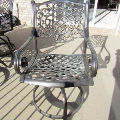 LOT 93  METAL PATIO TABLE WITH 6 SWIVEL CHAIRS