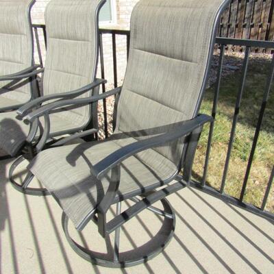 LOT 99  FOUR SWIVEL PATIO CHAIRS