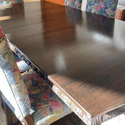 European dining table with carved base, two side chair and 8 dining chairs with nailhead trim