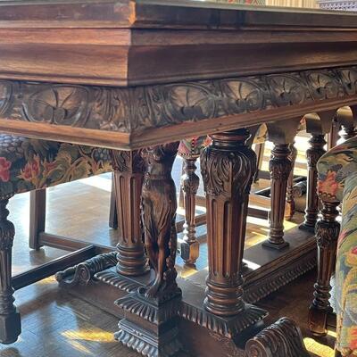European dining table with carved base, two side chair and 8 dining chairs with nailhead trim