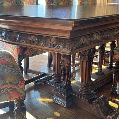 European dining table with carved base, two side chair and 8 dining chairs with nailhead trim