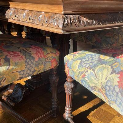 European dining table with carved base, two side chair and 8 dining chairs with nailhead trim