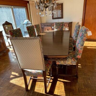 European dining table with carved base, two side chair and 8 dining chairs with nailhead trim