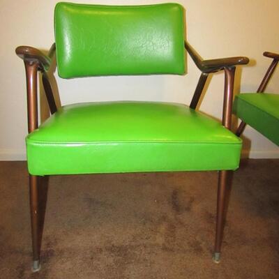 LOT 1  TWO MID-CENTURY MODERN VINYL ARM CHAIRS