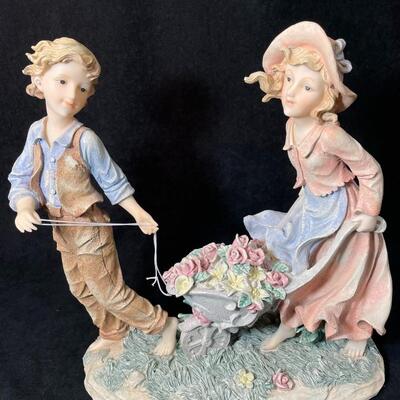 Lot 133  Couple with Wheelbarrow Figurine