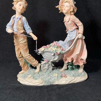 Lot 133  Couple with Wheelbarrow Figurine