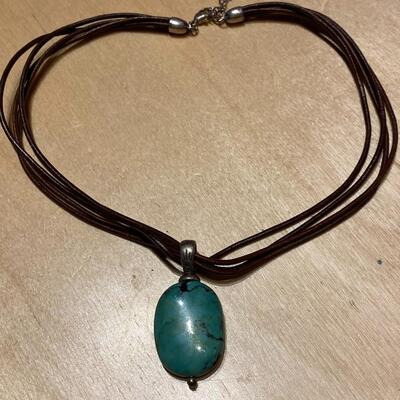 Leather strapped necklace with jade stone pendant