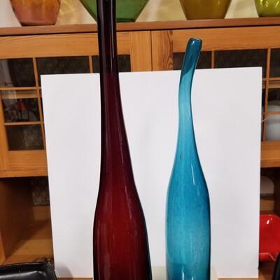 A pair of two tall Vintage solid color art glass sculptural bottles