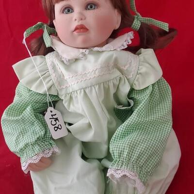 Doll in green white dress
