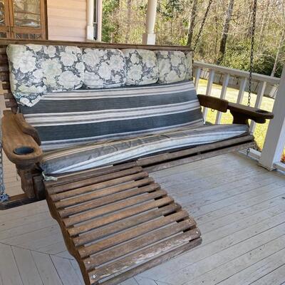Wooden Honey Rock porch swing with foot rest and cup holders